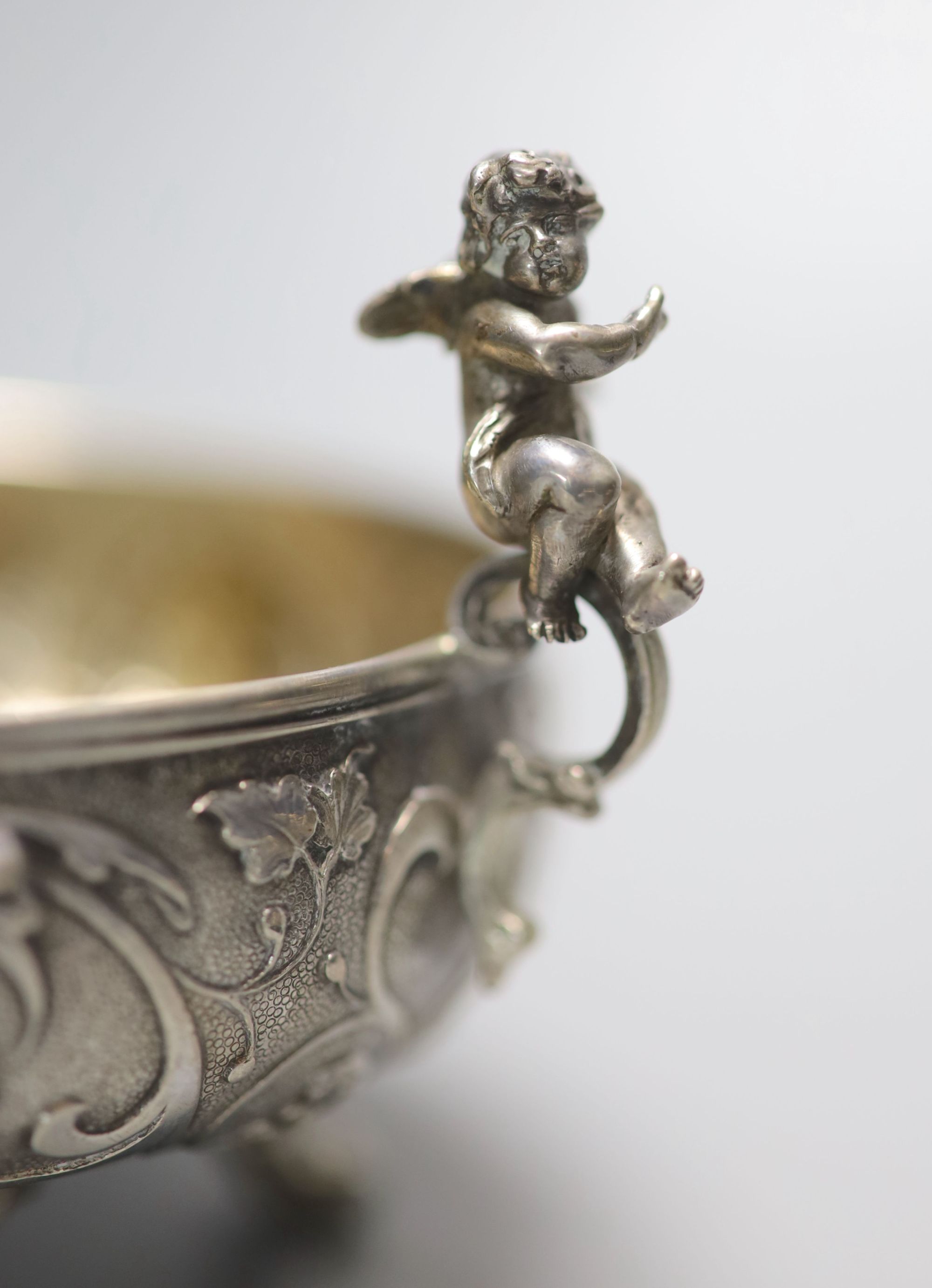 A pair of Italian white metal two handled sweetmeat bowls, by G Accarisi, with figural handles, dia. 85mm, 8oz.